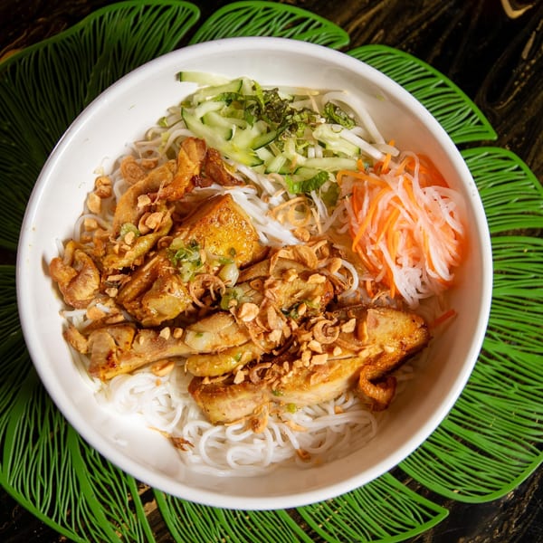 Vietnamese vermicelli bowl with grilled chicken, peanuts, fried onions, and pickled vegetables.